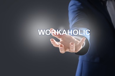 Image of Businessman and word Workaholic on dark grey background, closeup