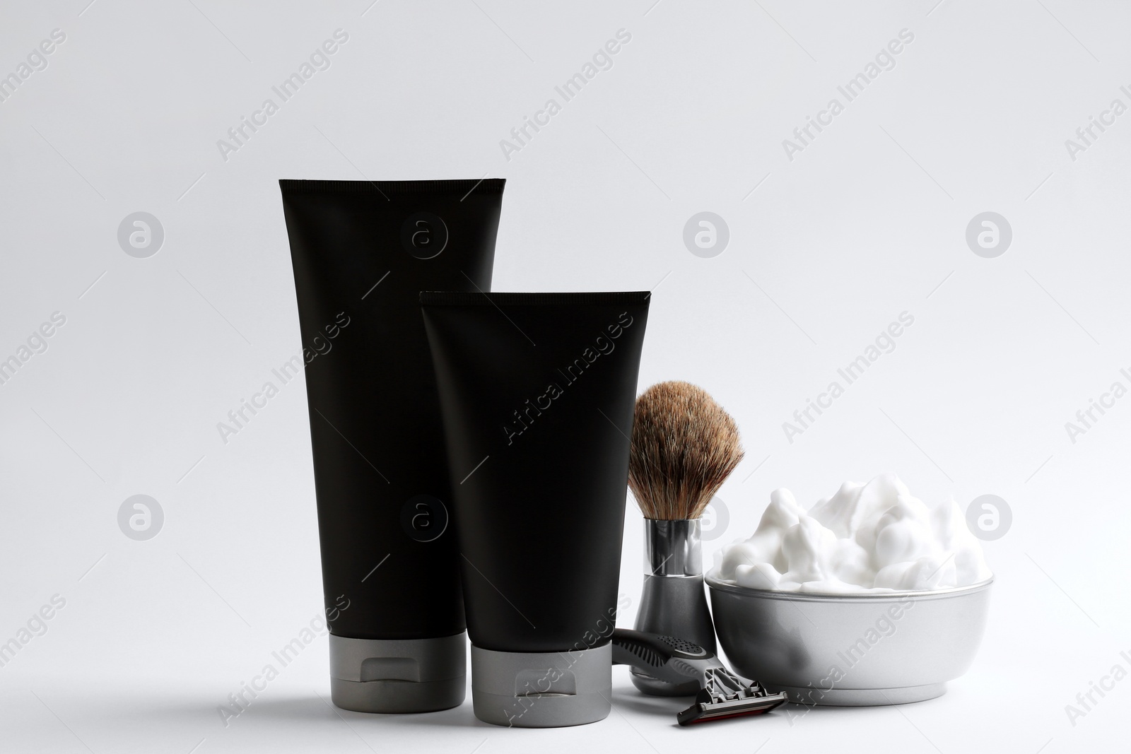 Photo of Set of shaving equipment and men's cosmetic products on light background