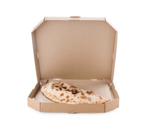 Photo of Cardboard box with delicious calzone on white background