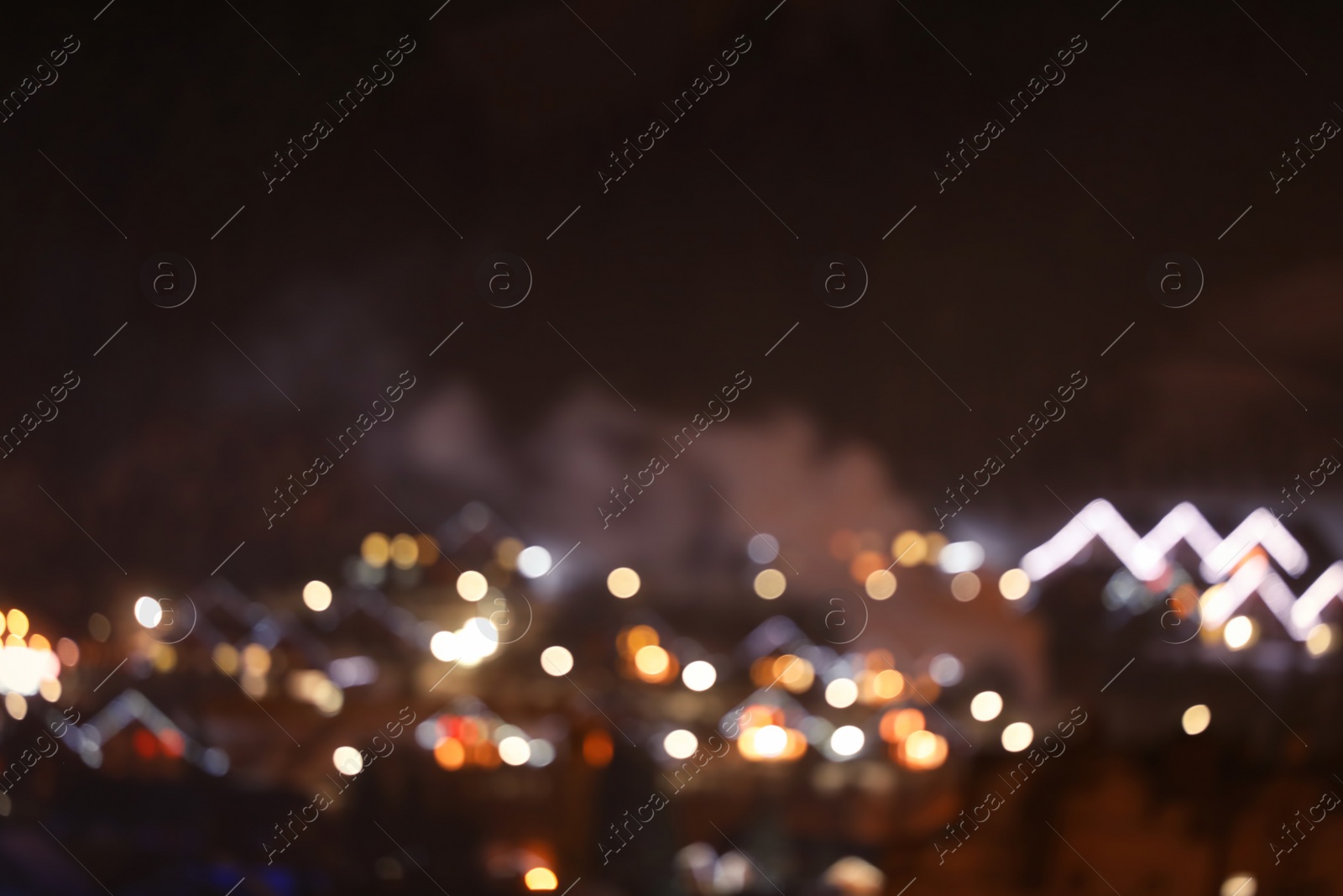 Photo of Blurred view of mountain village near forest in winter