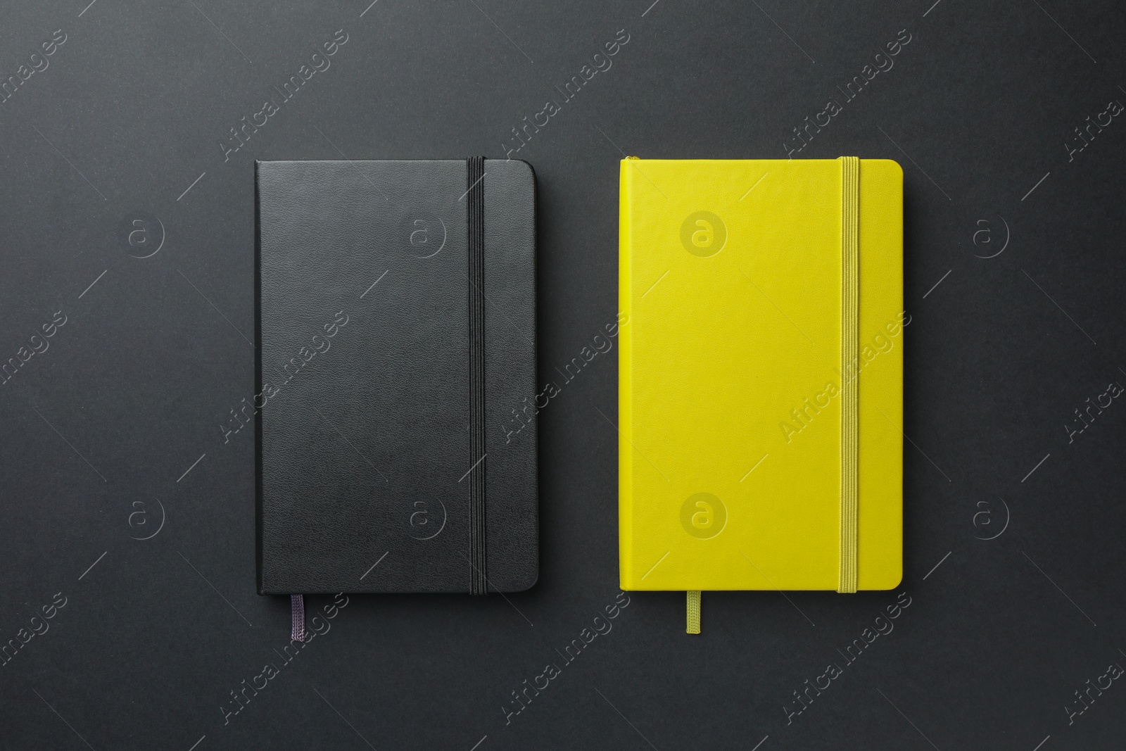 Photo of Different notebooks on black background, top view