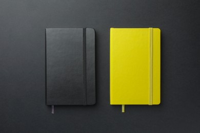 Photo of Different notebooks on black background, top view