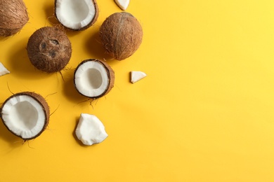 Photo of Flat lay composition with coconuts on color background. Space for text