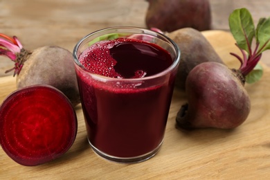 Photo of Freshly made beet juice on wooden table