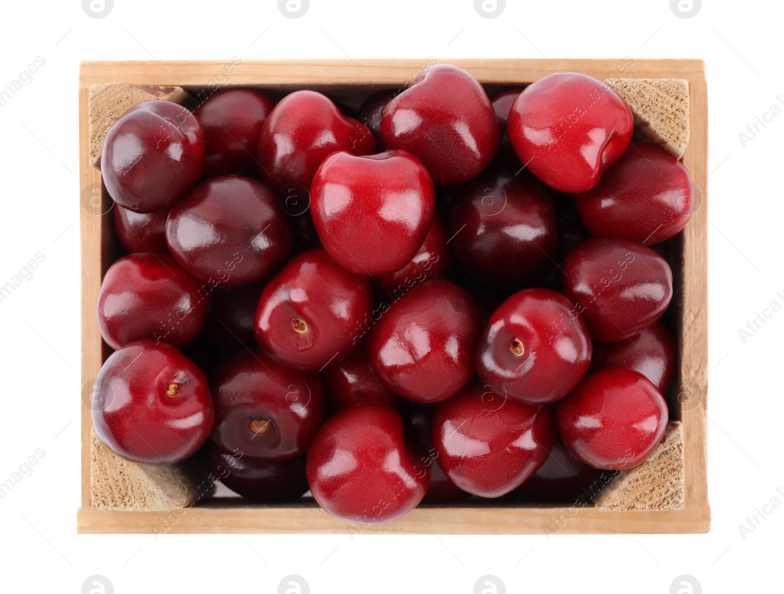 Photo of Tasty ripe red cherries in wooden crate isolated on white, top view