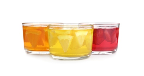 Tasty jelly desserts in glasses on white background