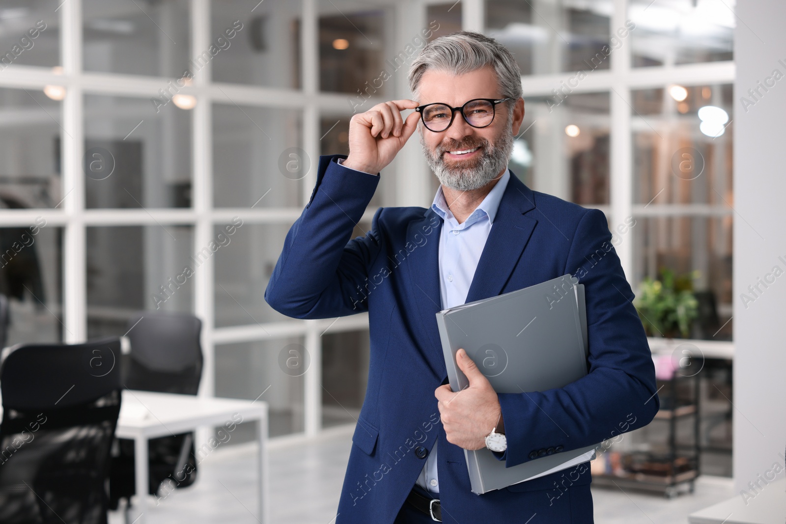 Photo of Portrait of smiling man with folder in office, space for text. Lawyer, businessman, accountant or manager