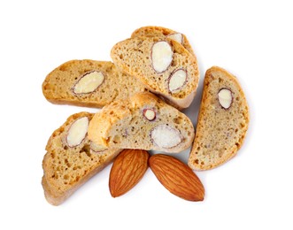 Photo of Slices of tasty cantucci and nuts on white background, top view. Traditional Italian almond biscuits
