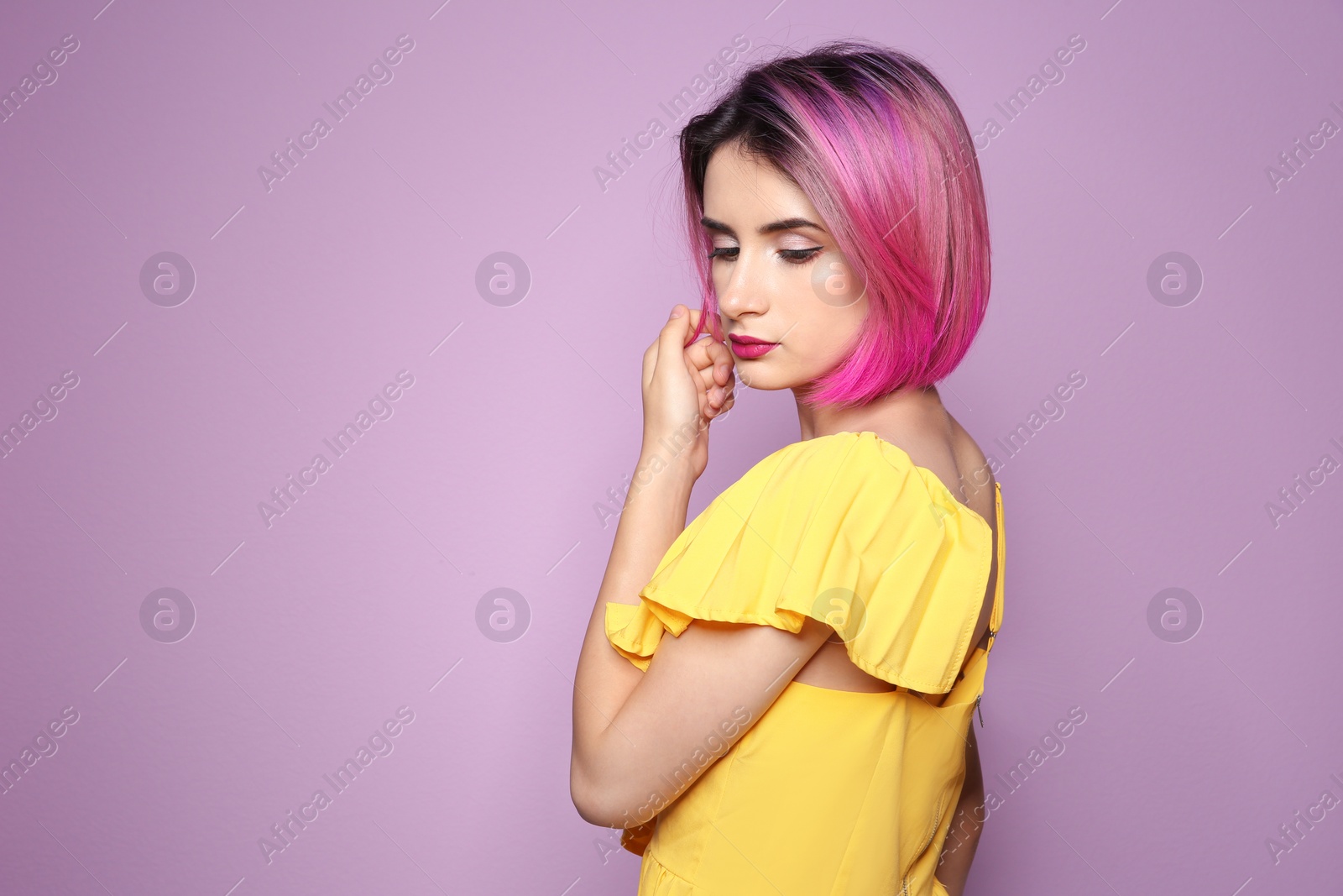 Photo of Young woman with trendy haircut against color background