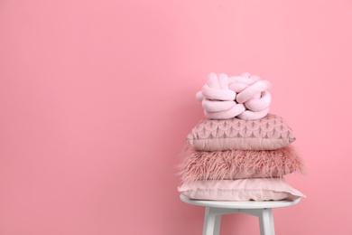 Photo of Chair with many different pillows and space for text on color background