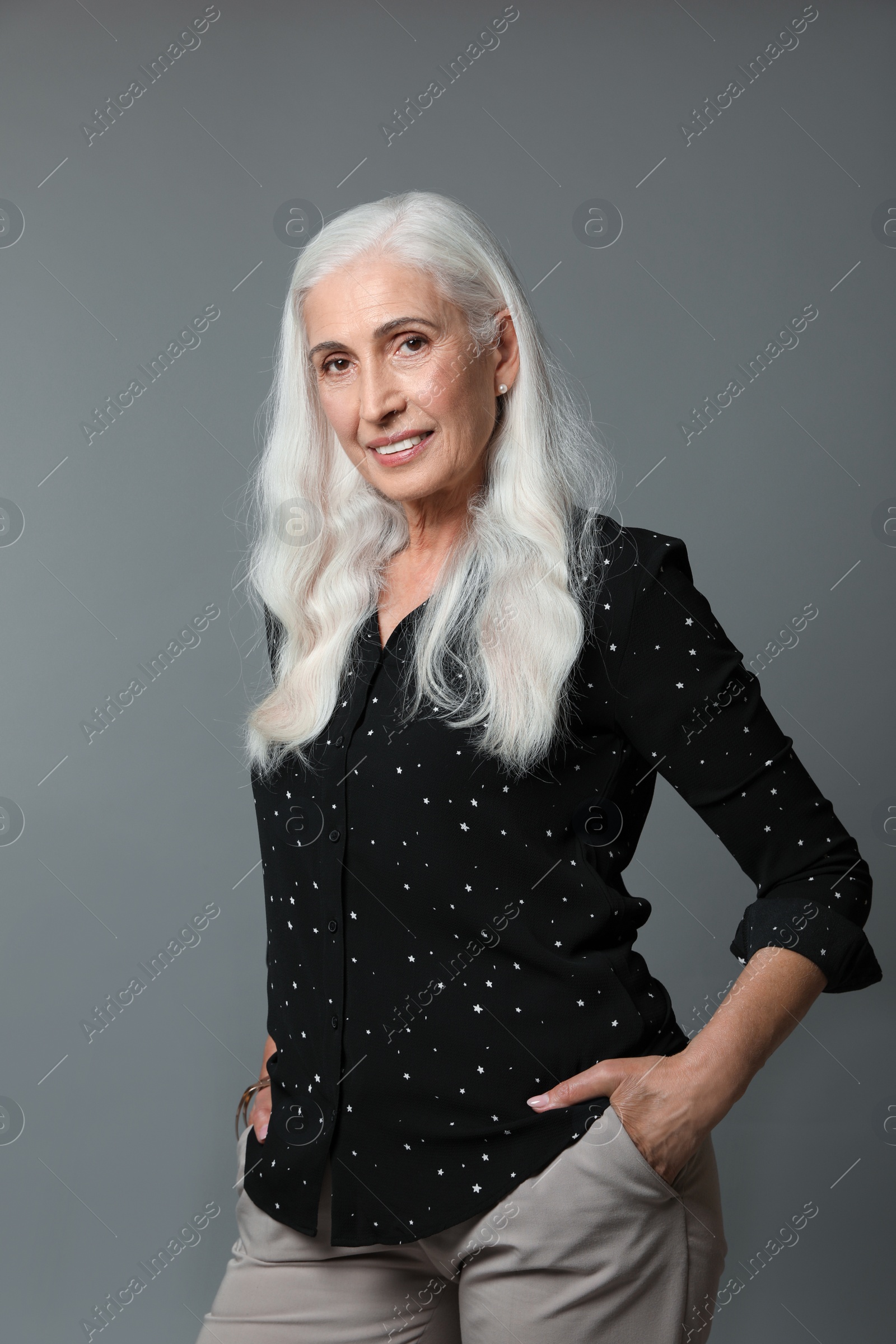 Photo of Portrait of beautiful mature woman on grey background