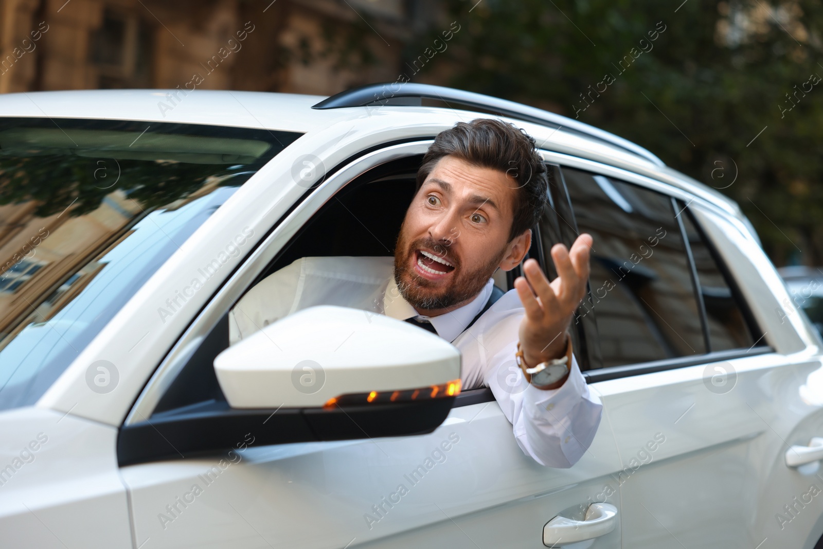 Photo of Angry driver screaming at someone from car in traffic jam