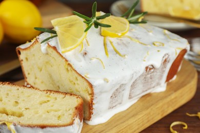 Tasty lemon cake with glaze on table, closeup