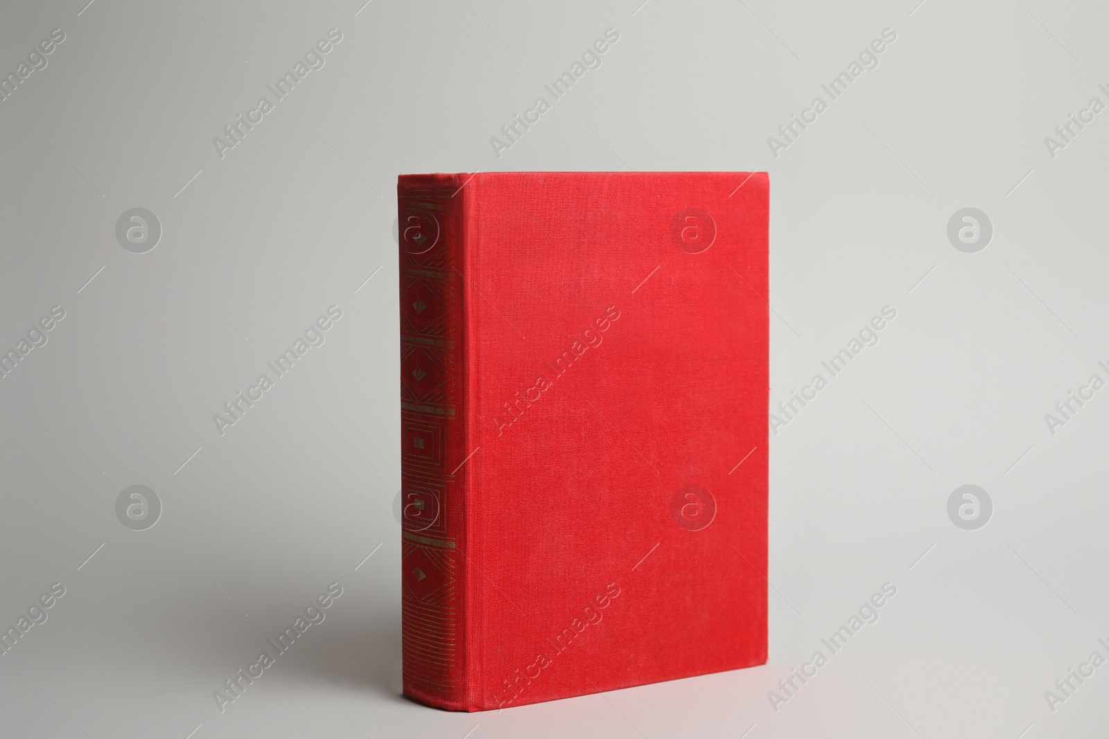Photo of Hardcover book on light grey background. Space for design