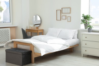Photo of Bed with soft white pillows in cozy room interior