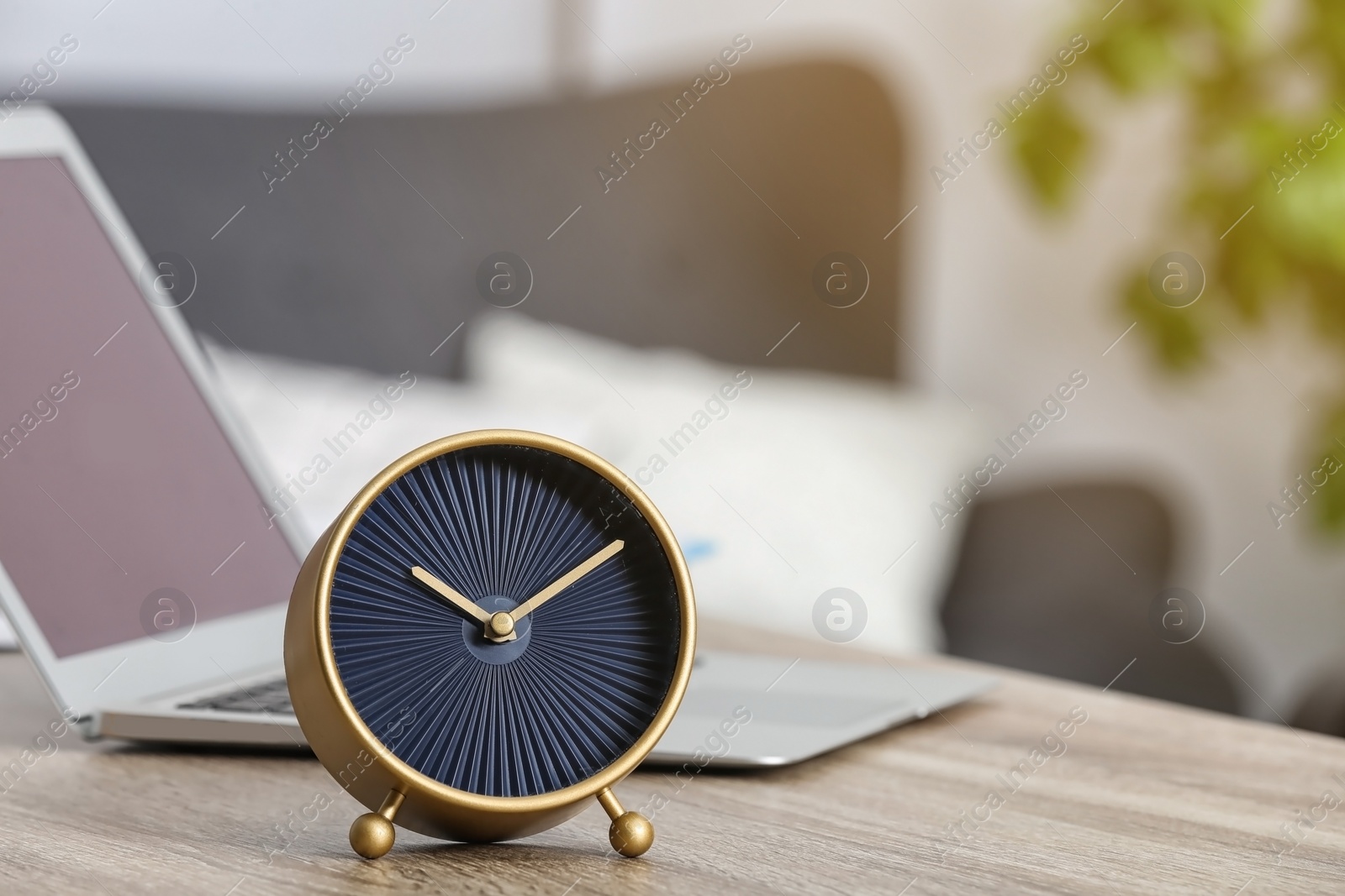 Photo of Workplace with stylish analog clock and laptop in office. Space for text