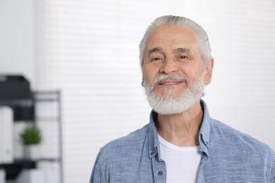 Photo of Portrait of handsome senior man in office. Space for text