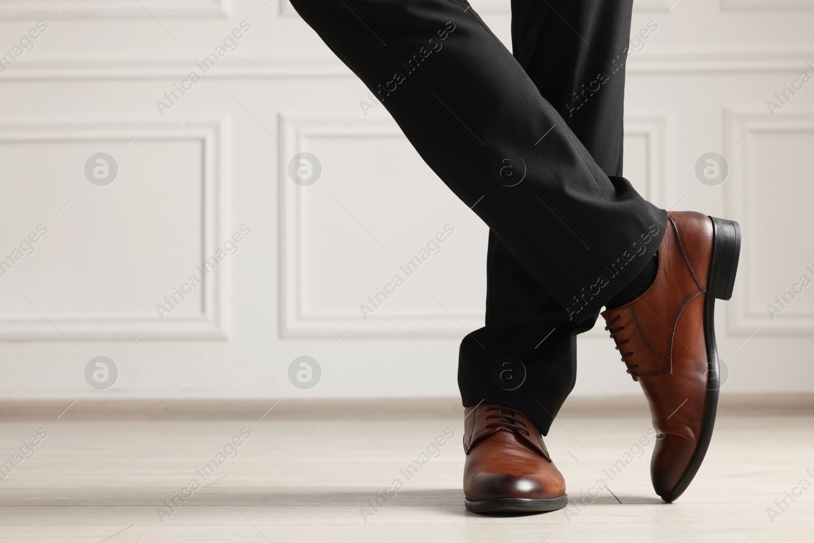 Photo of Businessman in elegant leather shoes indoors, closeup. Space for text