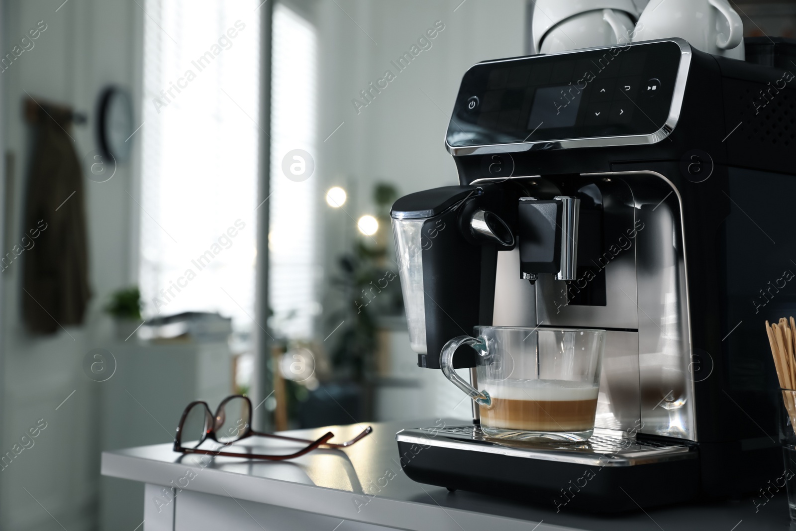 Photo of Modern coffee machine with cup in office. Space for text