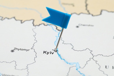 MYKOLAIV, UKRAINE - NOVEMBER 09, 2020: Kyiv city marked with flag push pin on contour map of Ukraine, closeup