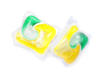 Photo of Two dishwasher detergent pods on white background, top view