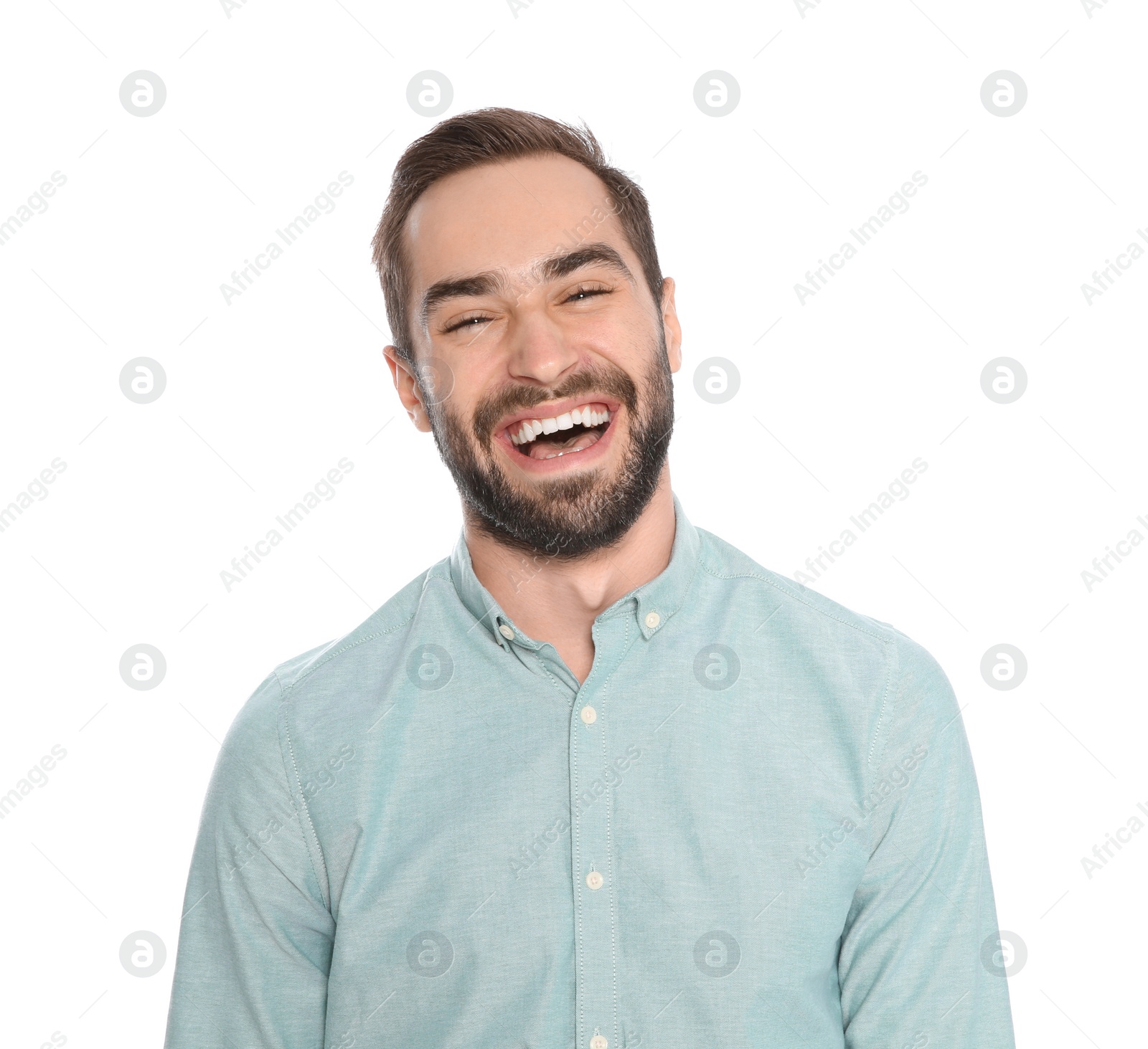 Photo of Portrait of young man laughing on white background