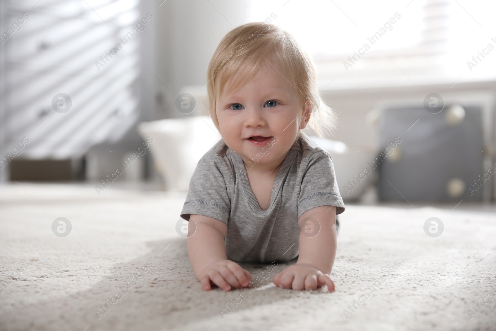 Photo of Adorable little baby on floor at home