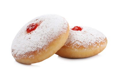 Photo of Delicious donuts with jelly and powdered sugar on white background