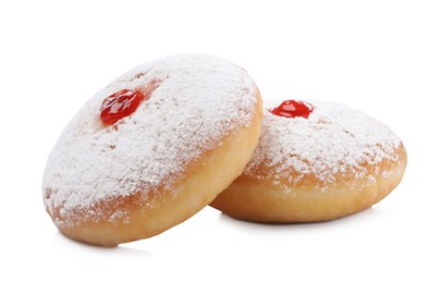 Delicious donuts with jelly and powdered sugar on white background