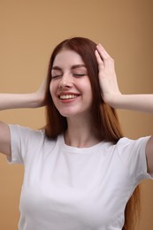 Photo of Portrait of smiling woman on beige background