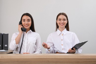 Female receptionists working at desk in hotel