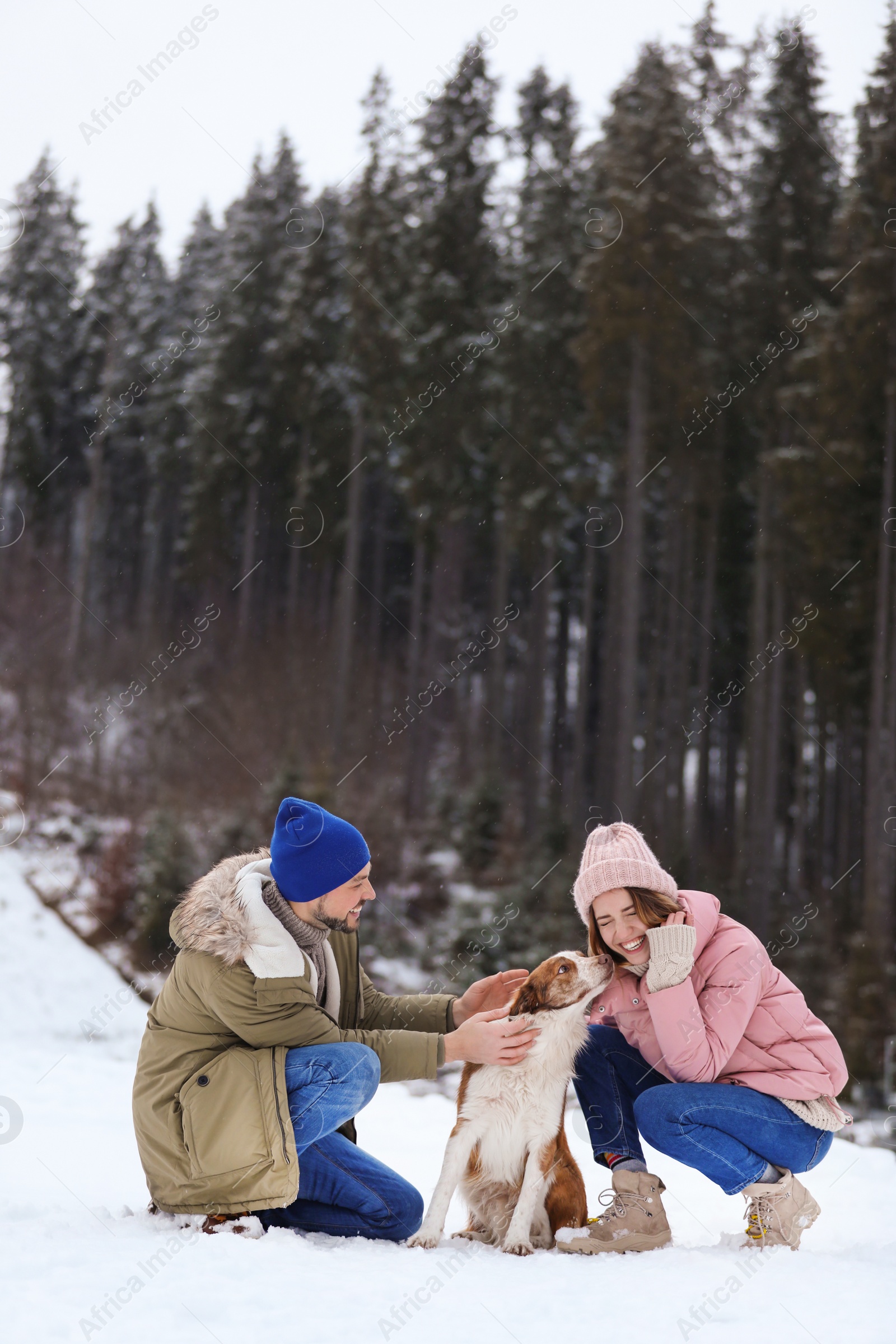 Photo of Couple with dog near forest, space for text. Winter vacation