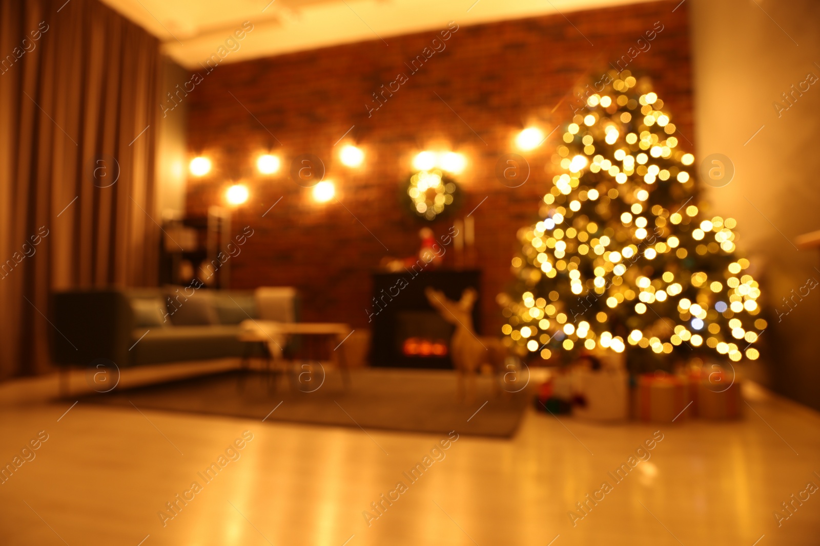 Photo of Blurred view of beautiful Christmas tree with lights in living room