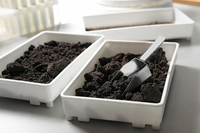 Photo of Containers with soil samples on table. Laboratory research