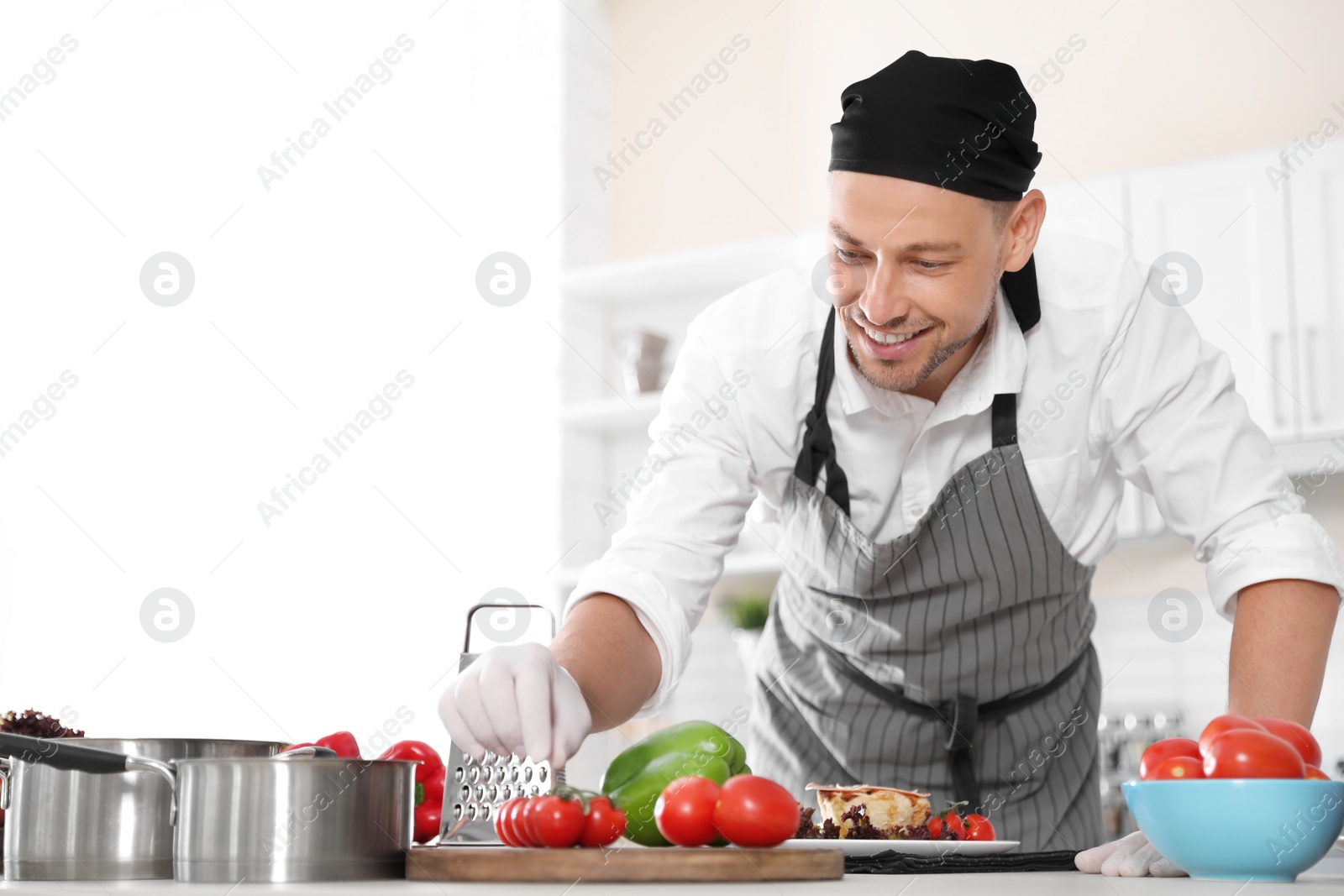 Photo of Professional chef in uniform working at restaurant kitchen