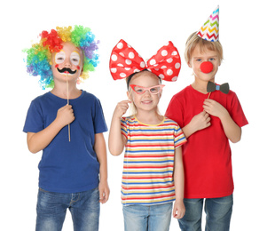 Photo of Cute children in funny costumes on white background. April fool's day