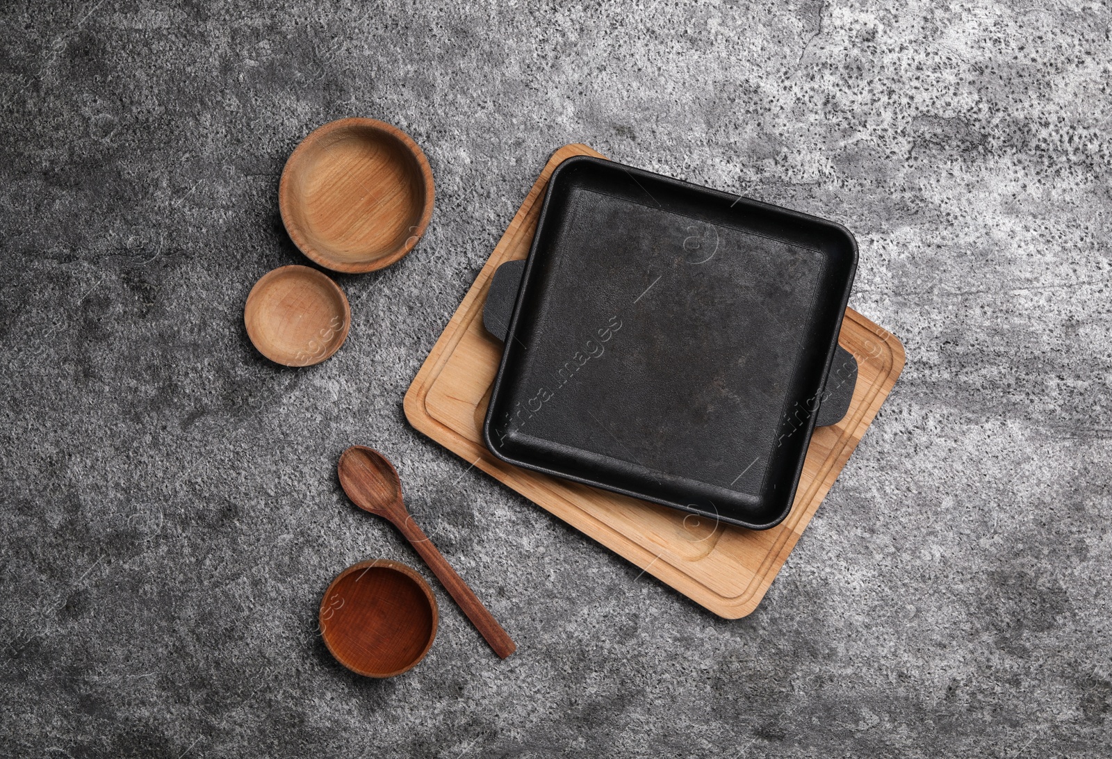 Photo of Set of cooking utensils on grey table, flat lay