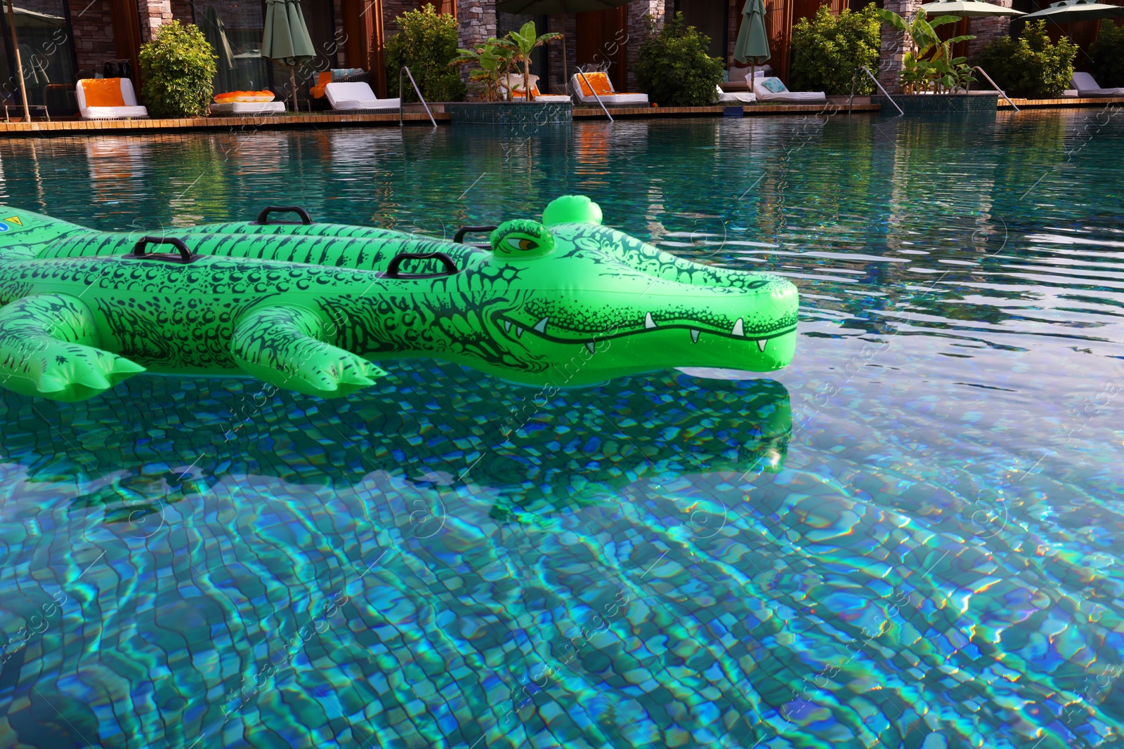 Photo of Float in shape of crocodile in swimming pool at luxury resort