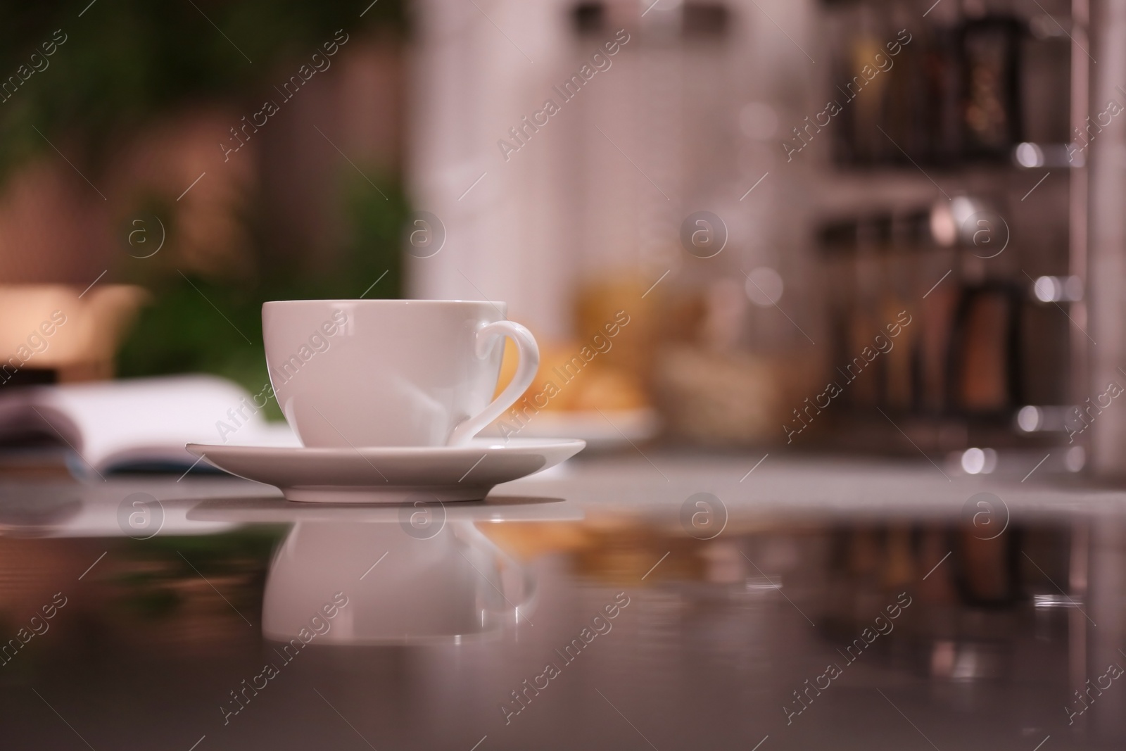 Photo of Cup of hot coffee on blurred background