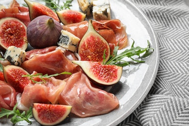 Plate with figs, prosciutto and cheese, closeup