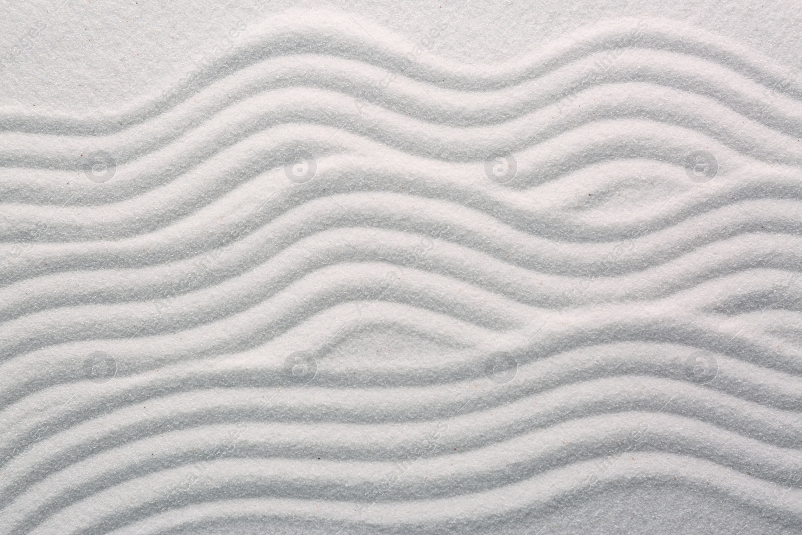 Photo of White sand with pattern as background, top view. Concept of zen and harmony