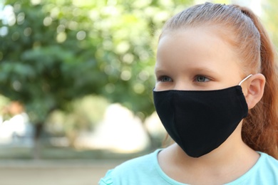 Preteen girl in protective face mask outdoors