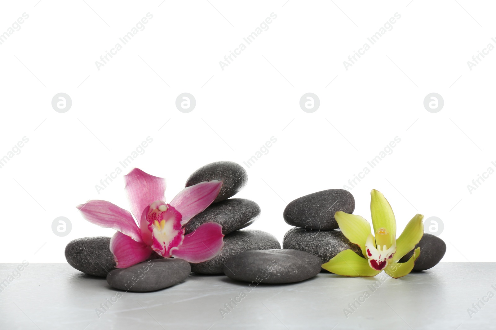 Photo of Beautiful orchid flowers with different spa stones on white background