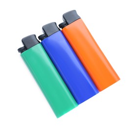 Stylish small pocket lighters on white background, top view