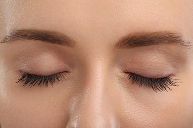 Photo of Woman with long eyelashes after mascara applying, closeup