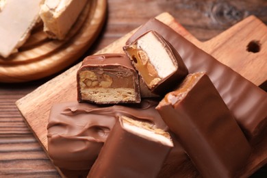 Tasty chocolate bars with nougat on table, closeup