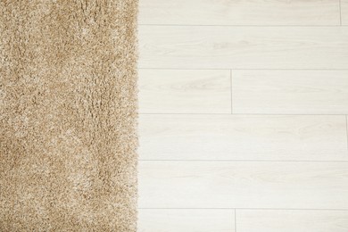 Beautiful beige carpet on floor, top view. Space for text