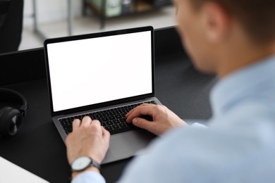 Photo of Man watching webinar at table in office, closeup