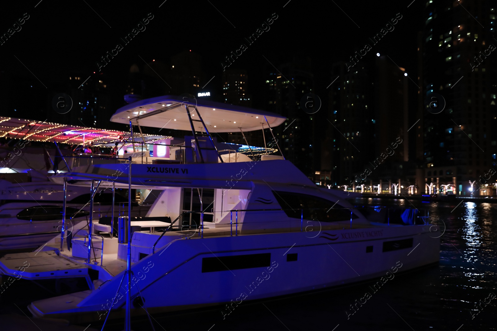 Photo of DUBAI, UNITED ARAB EMIRATES - NOVEMBER 03, 2018: Pier with luxury yachts at night