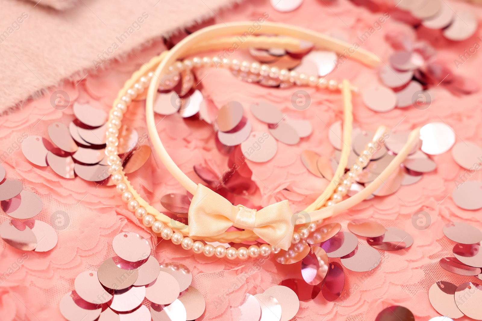 Photo of Stylish carnival costume with sequins and headbands, closeup